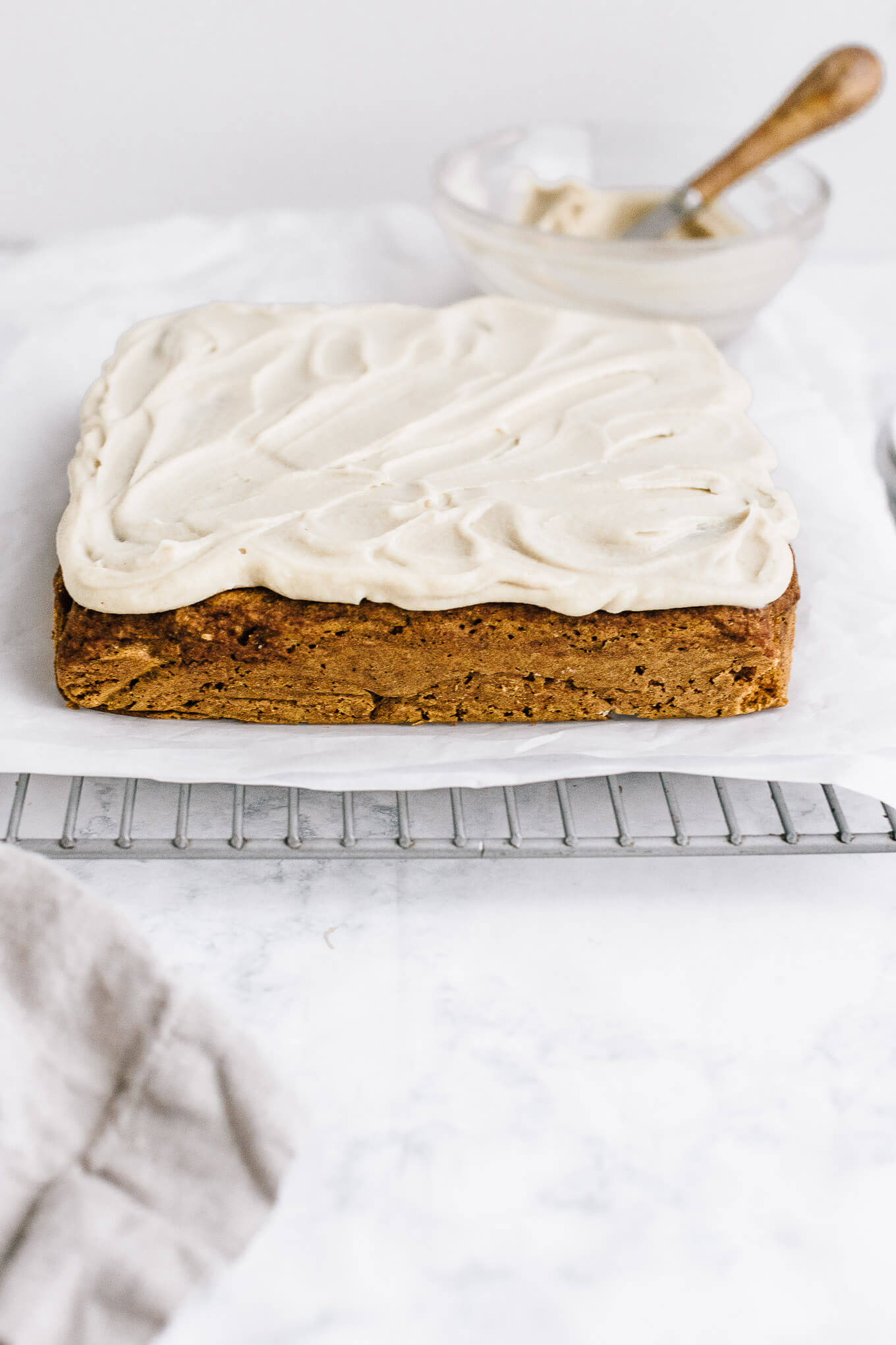 pumpkin snack cake with cashew buttercream on cooling rack