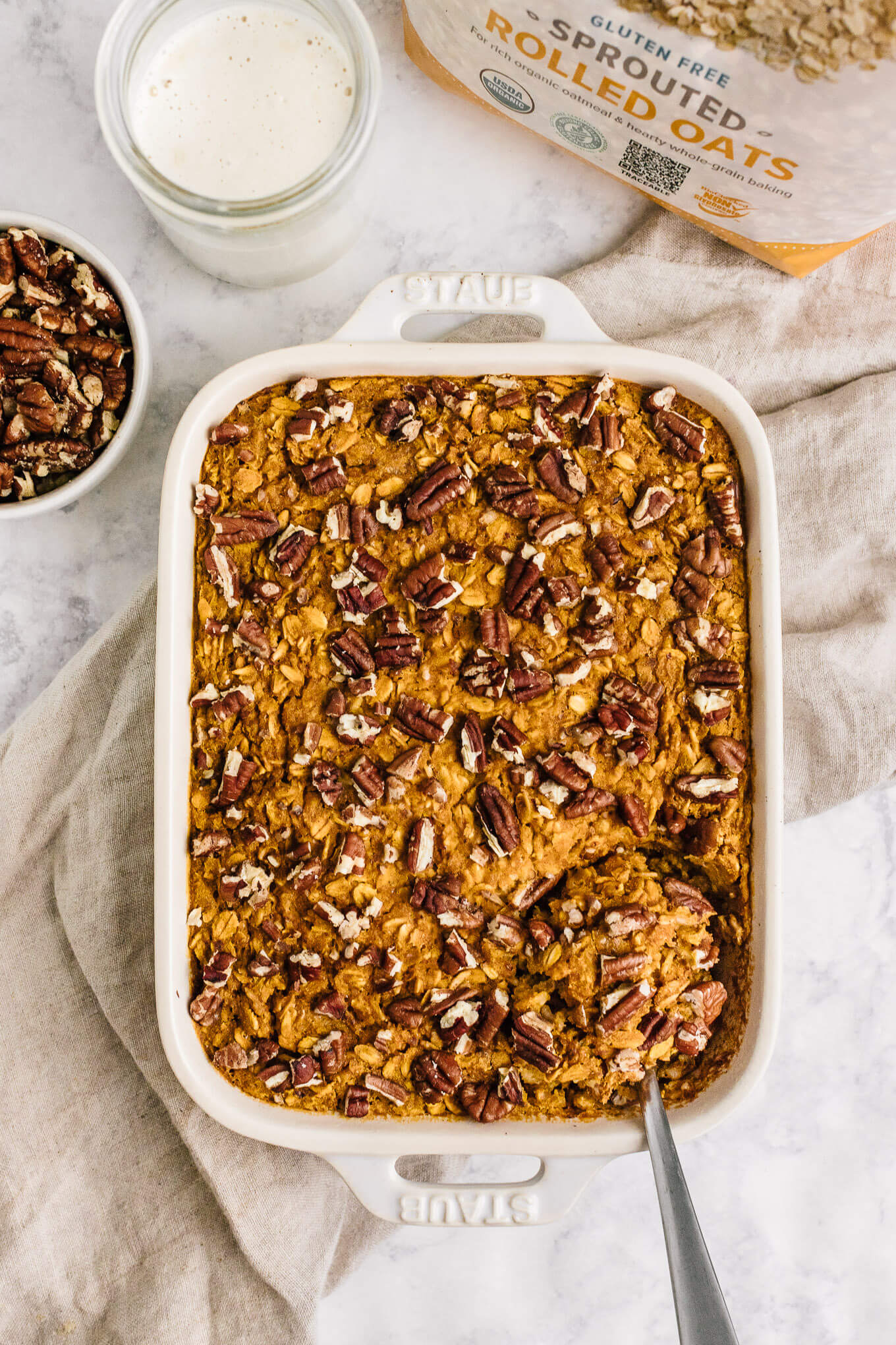 pumpkin baked oatmeal in Stuab pan with serving spoon
