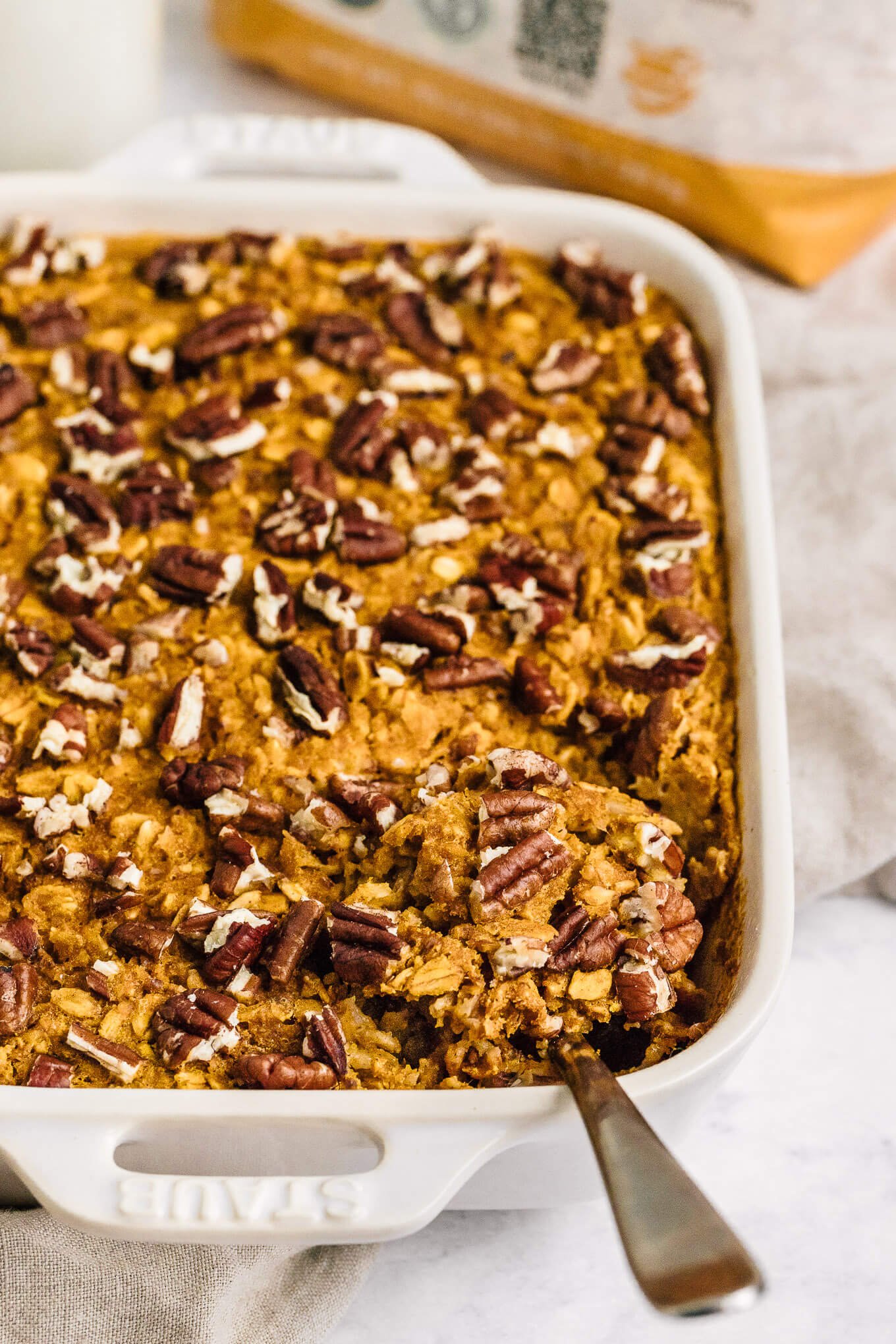 pumpkin baked oatmeal in Stuab pan with serving spoon