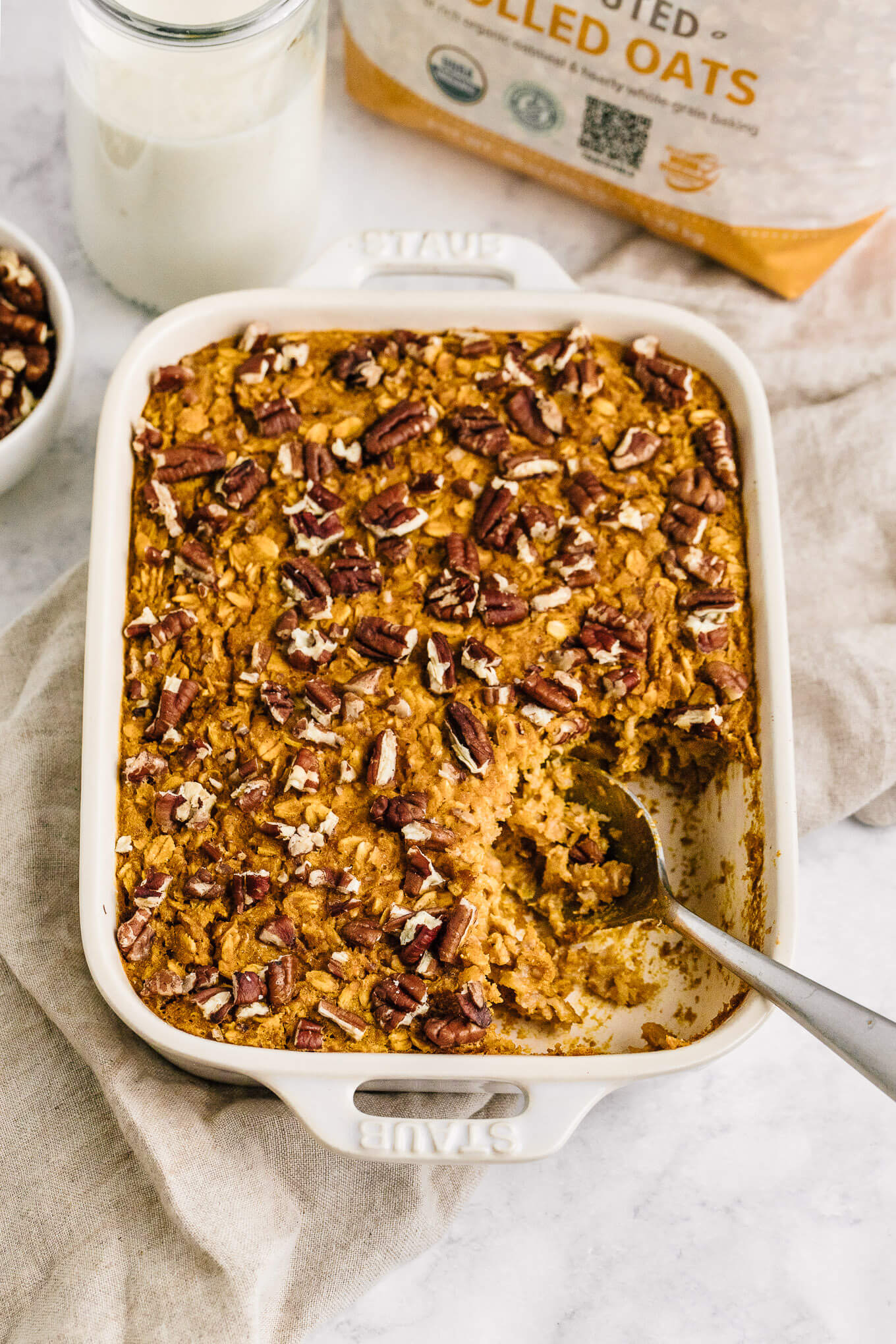 pumpkin baked oatmeal in Stuab pan with serving spoon 