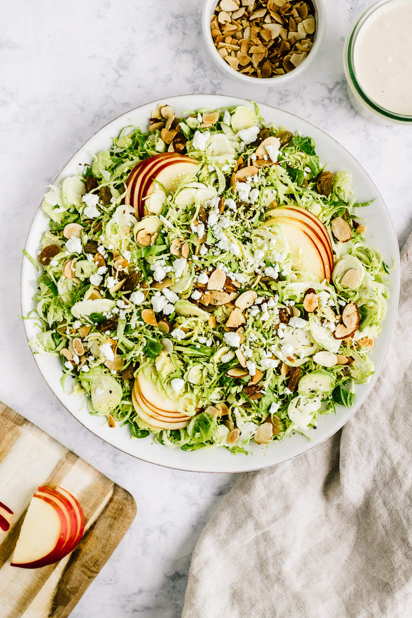 Shaved Brussels sprout and apples salad in serving bowl