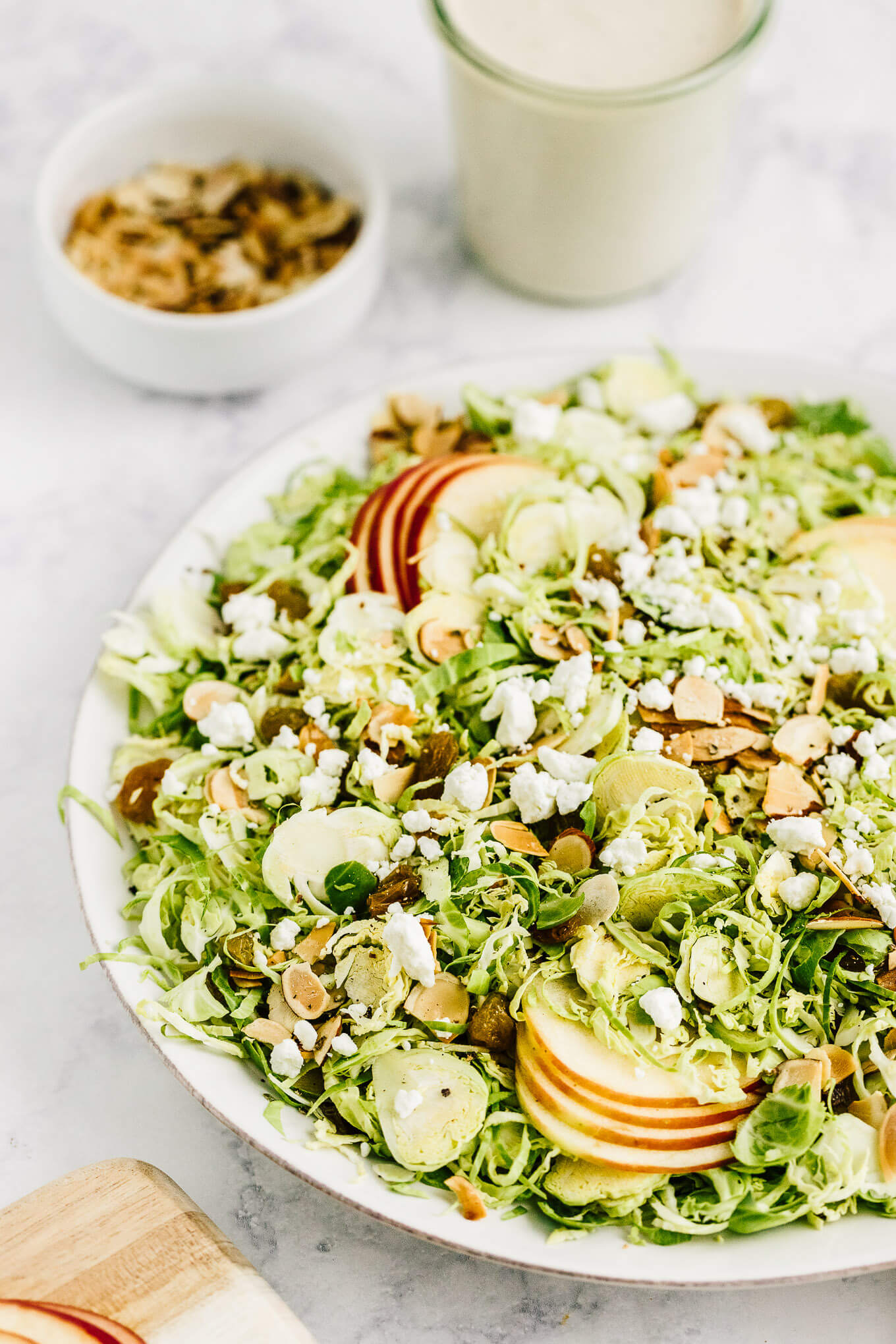 Shaved Brussels sprout and apples salad with golden raisins and goat cheese
