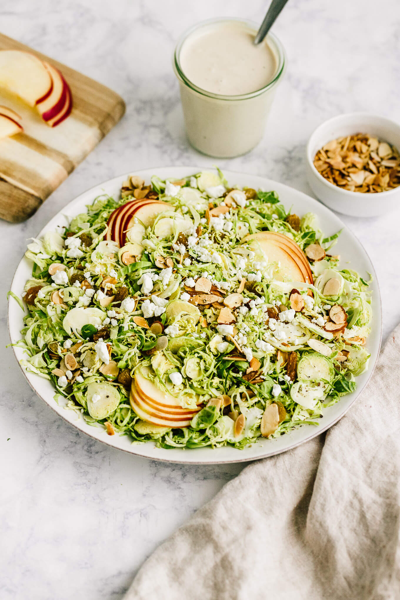 Shaved Brussels sprout and apples salad in serving bowl