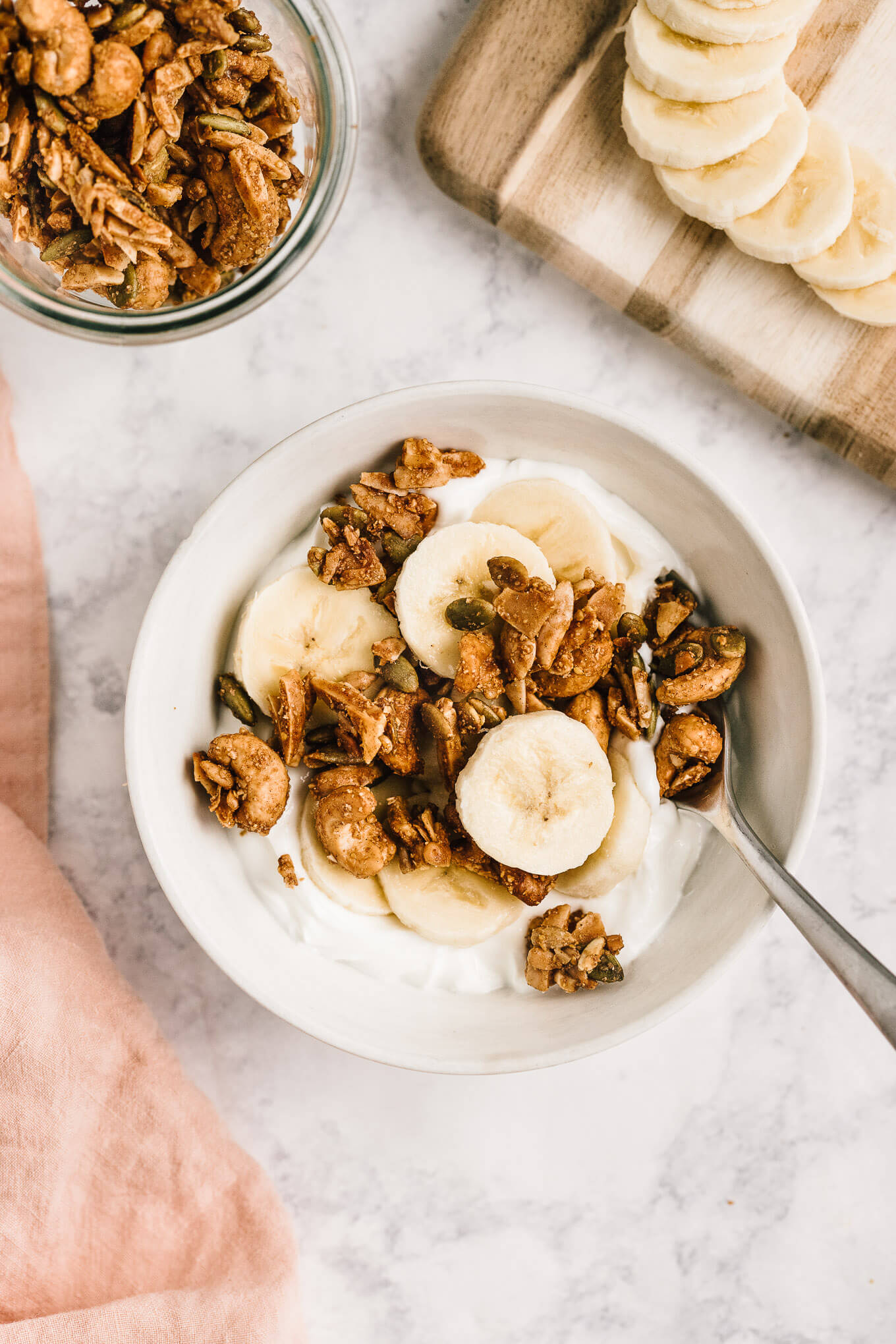 yogurt topped with paleo grain-free granola and bananas
