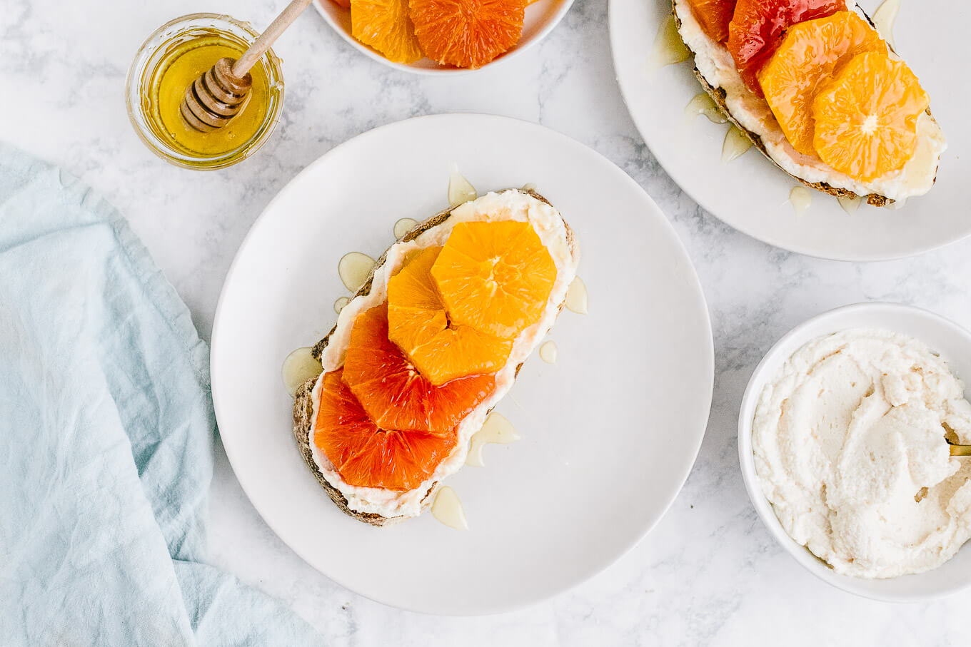 ricotta toast with orange slices and honey on plate