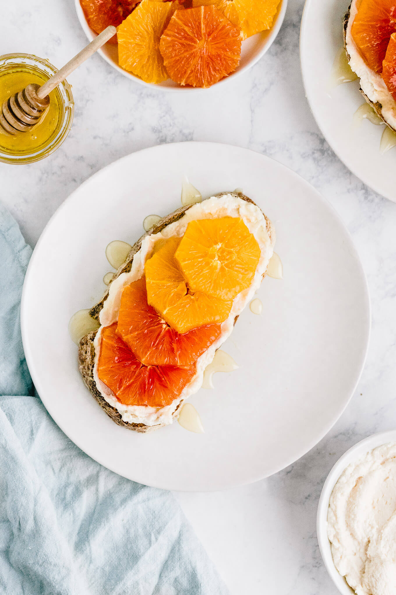 ricotta toast with orange slices and honey on plate