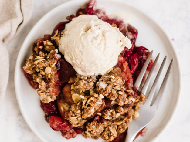 Healthy cranberry apple crisp with oat topping and ice cream; vegan, gluten-free