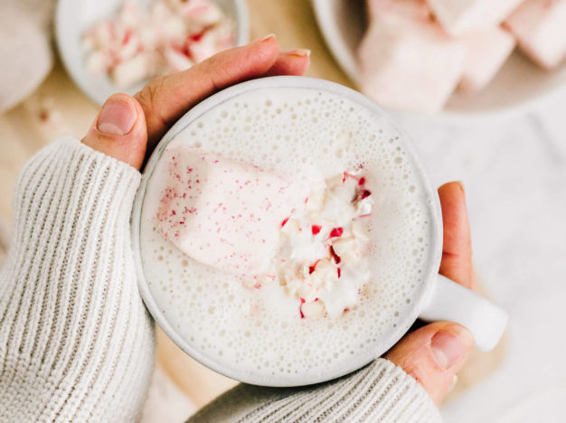 hands holding vegan peppermint white hot chocolate