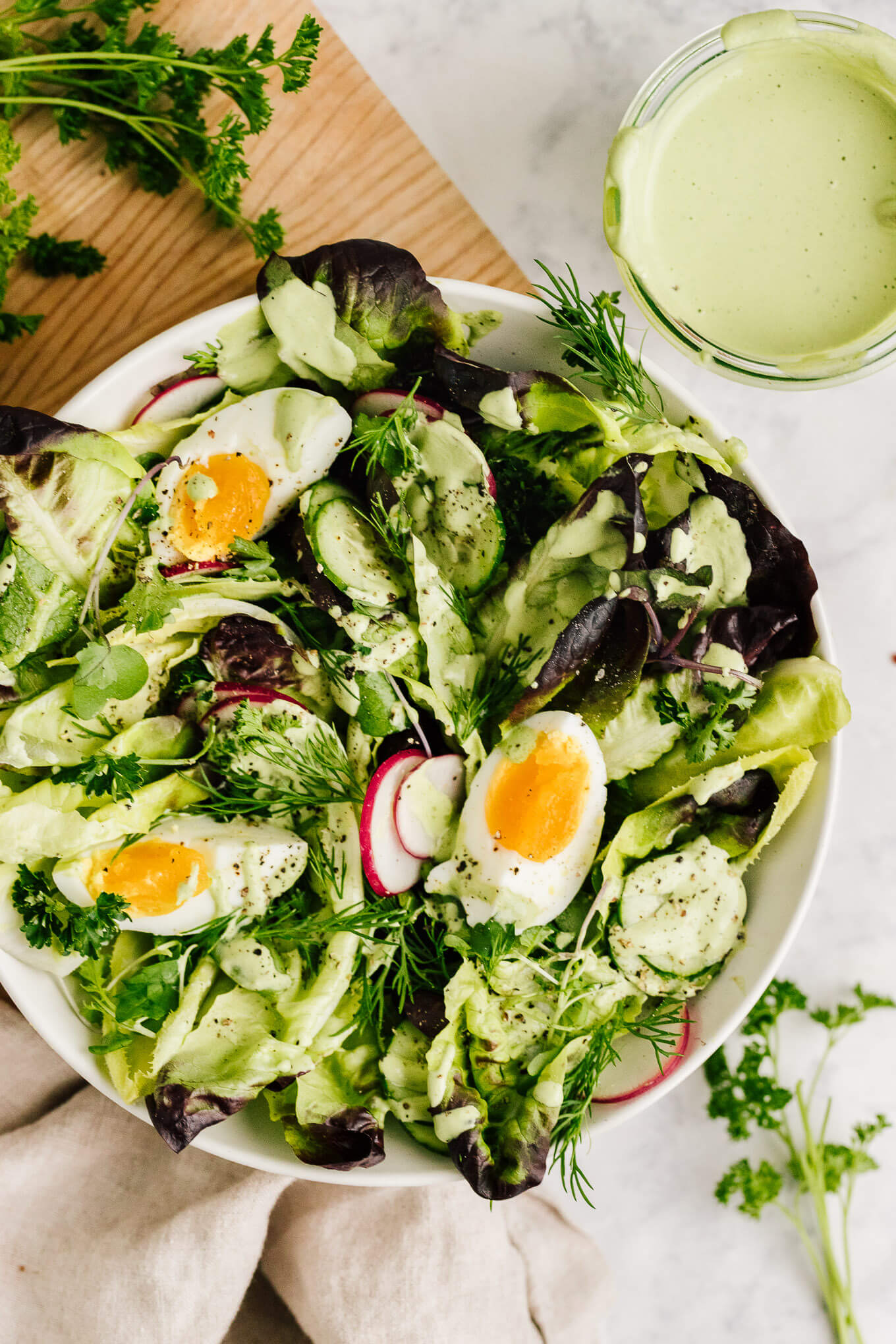 Spring salad with jammy eggs and green goddess dressing made with cashews. Dairy-free.