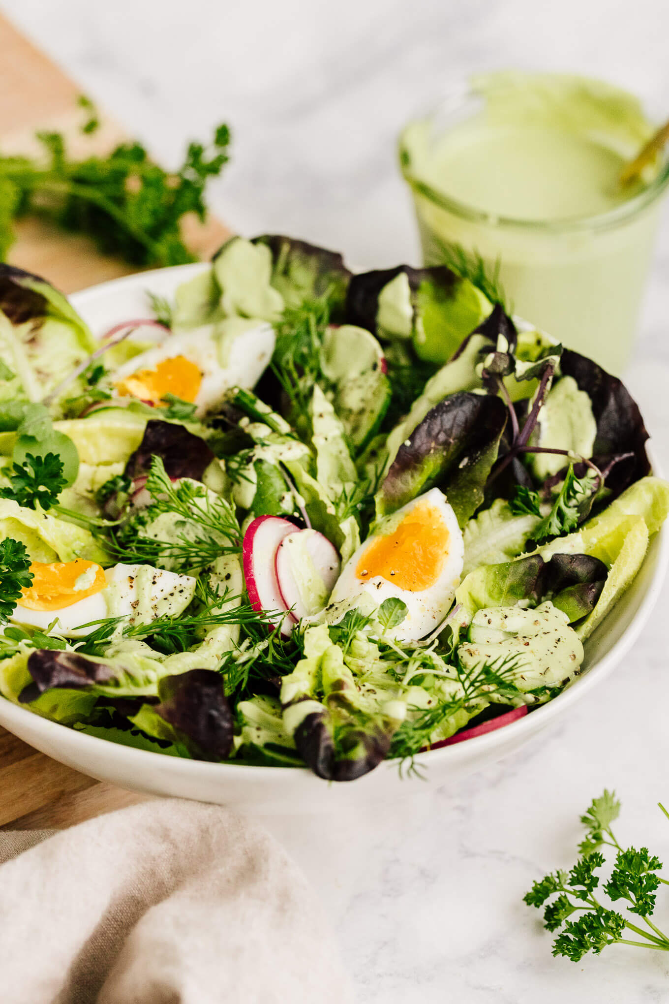 Spring salad with jammy eggs and green goddess dressing made with cashews. Dairy-free.