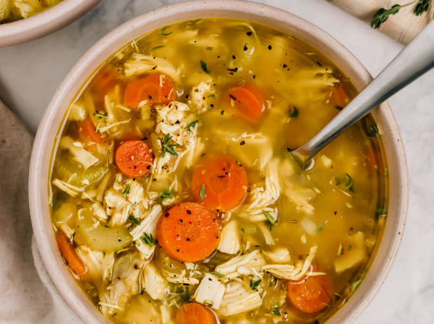 A nourishing chicken soup with no noodles that comes together quickly using rotisserie chicken. It's a veggie-loaded chicken no noodle soup with herbs and a touch of turmeric and lemon. Grain-free, Gluten-free and paleo friendly.